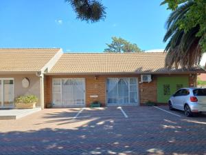a house with a car parked in a parking lot at Ceelee's Place in Bloemfontein +7 photos