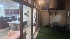 a living room and kitchen with a table and chairs at GBL Reine Chateau in Polokwane