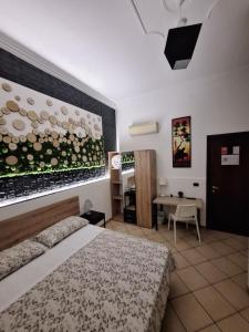 a bedroom with a bed and a table in it at Fontanarossa Airport Home in Catania