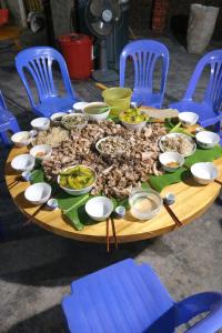a table with a bunch of food on it at Tả Mẩy Homestay in Lao Cai