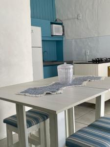 a kitchen with a table with a bowl on it at Vista Mar Praia da Lagoinha - Residencial Pé na Areia in Bombinhas +26 photos