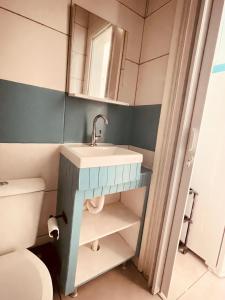 a bathroom with a sink and a toilet at Vista Mar Praia da Lagoinha - Residencial Pé na Areia in Bombinhas