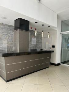 a kitchen with a counter with lights above it at Seven Eleven Apartments - Isibaya House in Johannesburg