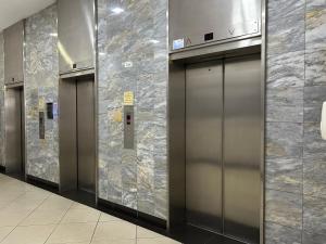 a row of elevator doors in a building at Seven Eleven Apartments - Isibaya House in Johannesburg