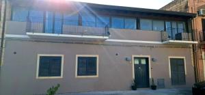 a house with a balcony with a door and a balcony at Fontanarossa Airport Home in Catania