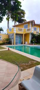 a house with a swimming pool in front of it at Casa inigualavel in Caucaia