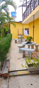 a group of tables and benches in a courtyard at Casa inigualavel in Caucaia