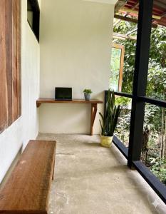 a room with a bench and a laptop on a table at Utria hostel in El Valle