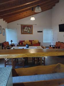 a living room with a large wooden table at Cabañas Rincon Verde in Merlo