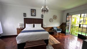 a bedroom with a large bed and a desk at GBL Reine Chateau in Polokwane +44 photos