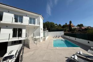 a house with a swimming pool next to a building at Casablanca-Private Family Mountain Home in El Amunt