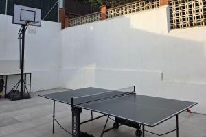 a black ping pong table with a basketball hoop at Casablanca-Private Family Mountain Home in El Amunt