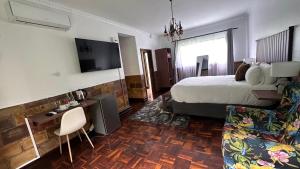 a hotel room with a bed and a television at GBL Reine Chateau in Polokwane