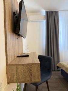 a room with a desk with a tv and a chair at Hotel Previla in Sarajevo