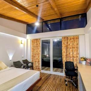 a bedroom with a bed and a room with a window at Stay At Cottages in Pynursla