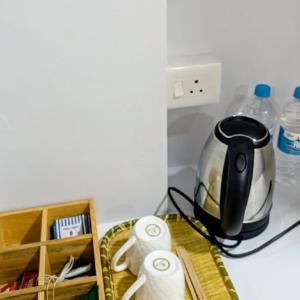 a tea kettle and some toilet paper on a counter at Stay At Cottages in Pynursla