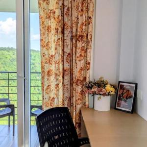 a room with a table and a curtain and a window at Stay At Cottages in Pynursla