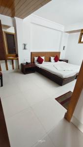 a bedroom with a bed and a television in it at Hotel Millilium Inn in Gangtok