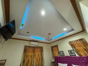 a ceiling with a tv and a purple couch at Ruen Thong Resort in Phang-nga