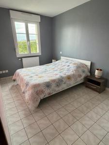 a bedroom with a bed and a window at Sylvain & Barbara in Pendé