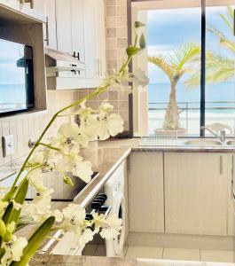 a kitchen with a counter with a sink and a dishwasher at Sea Sunny View Apartment in Margate
