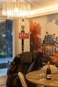 a living room with a table and a bottle of wine at Premium Spa Suite Jacuzzi Hot Tub Massage Chair near Paris Eiffel Tower-Stade de France-CDG Airport in Drancy