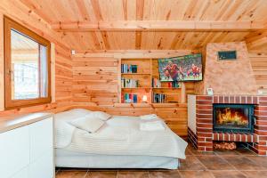 a bedroom with a bed and a fireplace at Ferienhaus Ustronie I Nr 1 in Ustronie Morskie