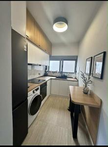 a kitchen with a table and a stove and a refrigerator at Rhodes center Santa Marina in Rhodes Town +2 photos