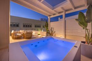 a large hot tub on a balcony with a patio at Rhodes center Santa Marina in Rhodes Town