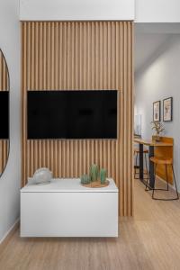 a living room with a flat screen tv on a wooden wall at Rhodes center Santa Marina in Rhodes Town