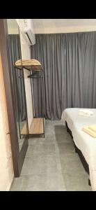 a room with two beds in front of a curtain at Umbrella4 in La Rioja
