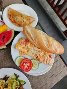 three plates of food on a table with food at Moonlight Boutique Hotel in Hue