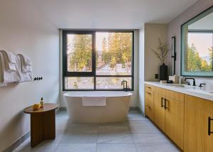 a large bathroom with a tub and a window at Limelight Mammoth in Mammoth Lakes +43 photos