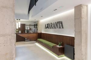 a lobby of a restaurant with a green bench at Amaranta Hotel Boutique in Ronda