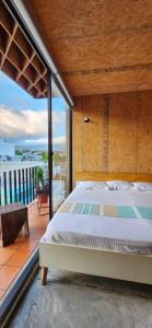 a bedroom with a large bed on a balcony at Hotel Momotus Tuxtla, en el centro - Acceso autónomo in Tuxtla Gutiérrez