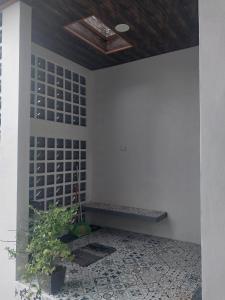 a room with a bench on a wall with a plant at Homestay Berlian T in Alastuwo