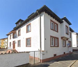 a white building with a black roof at COZEE - The Oasis in Kaiserslautern