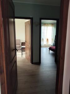 an open door to a living room with a dog in the window at Malpensa - Bilocale indipendente in Samarate