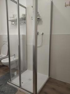 a glass shower stall in a bathroom with a toilet at Malpensa - Bilocale indipendente in Samarate +9 photos