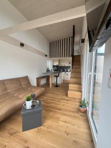 a living room with a couch and a table at Tinyhaus Ferien in Eggolsheim