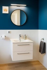 a bathroom with a white sink and a mirror at Domki Przystań Kotwica in Jastrzębia Góra +60 photos