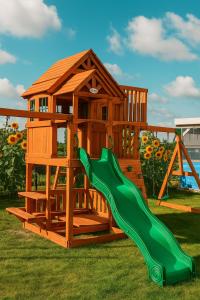 a wooden playset with a slide and a house at Domki Przystań Kotwica in Jastrzębia Góra