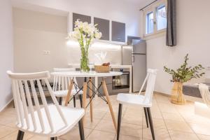 a kitchen and dining room with a table and chairs at Little Yard Studios & Apartments #4 in Naxos Chora