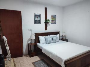 a bedroom with a bed with white sheets and pillows at Hatton Easy Stay in Hatton