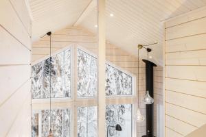 a room with a large window in a forest at Villa Mokum by PolarVillas in Kittilä +33 photos