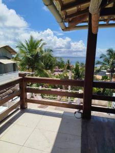 a balcony with a fence and a view of the ocean at Varanda das Palmeiras in Cairu