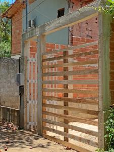 a wooden fence on the side of a brick building at Recanto Antônio Costa in Paraty