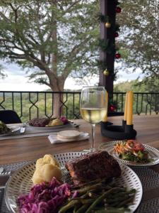 a table with a plate of food and a glass of wine at El Respiro Ecolodge in Granada