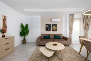a living room with a couch and a table at Lila Residence - by Solinis Homes in Bucharest