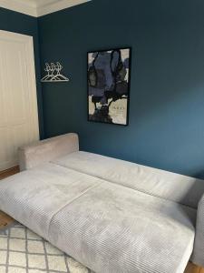 a bed in a bedroom with a blue wall at Greenbrook - Blue Lounge in Aalborg